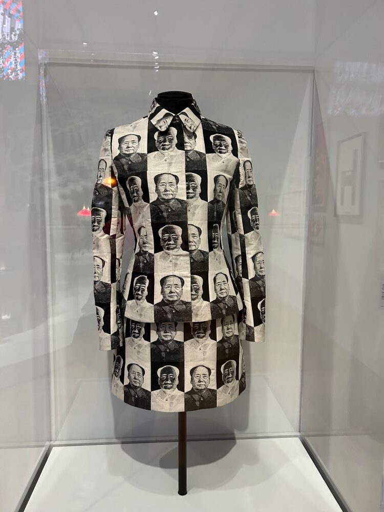 A black and white shirt jacket with a Mao's face on it.