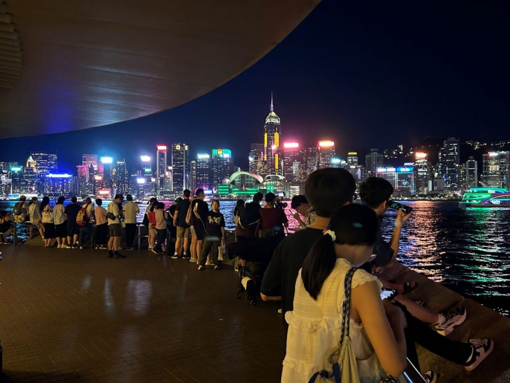 People line up on the waterfront to watch the Hong Kong symphony of lights show.
