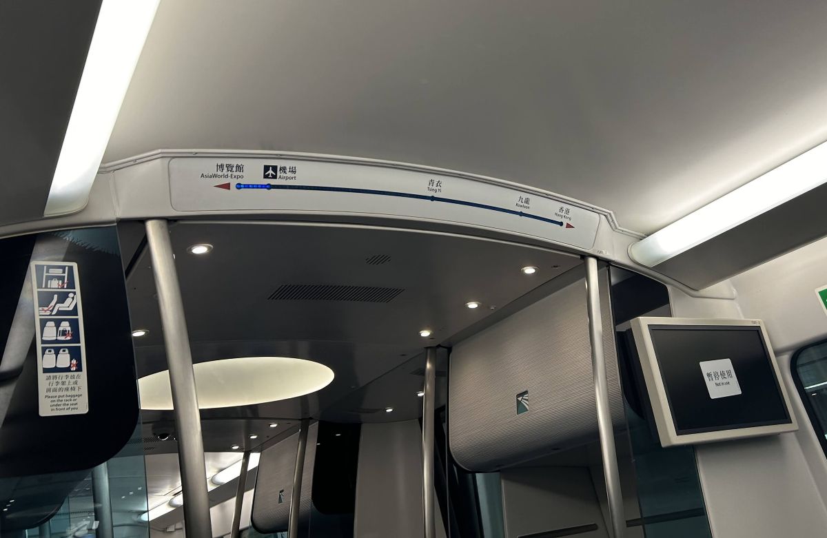 Route map and signage inside the Hong Kong Airport Express train, showing stops between the airport and Hong Kong Station.